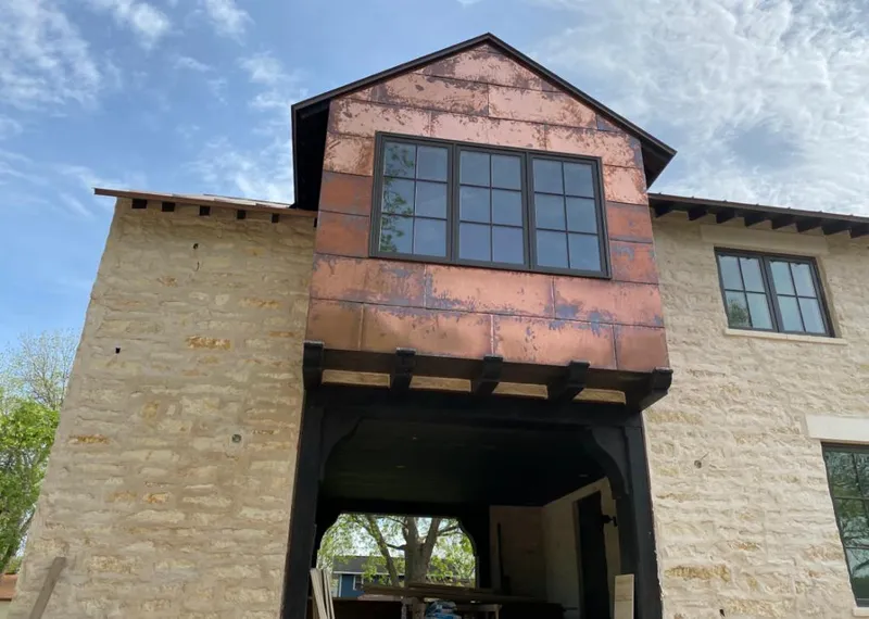 Copper metal panel facade on a stone building for Skylight Installation in Rockport